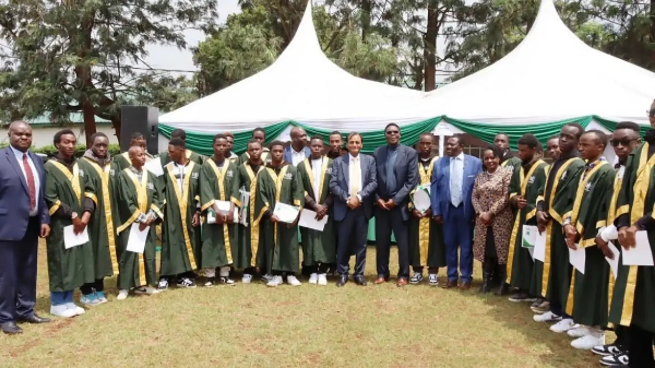 Candidates in green and gold gowns at a recognition ceremony